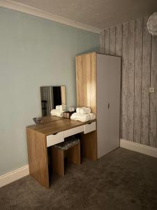 a bathroom with a wooden vanity with a mirror at Bronallt in Barmouth