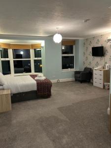 a bedroom with a bed and a living room at Bronallt in Barmouth