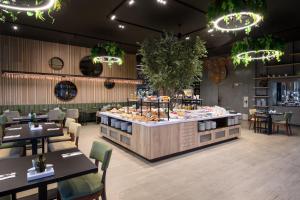 a restaurant with a counter with food on it at Melia Braga Hotel & Spa in Braga