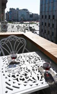 a white table with two glasses on a balcony at Architect's Art House right on Taksim Square in Istanbul