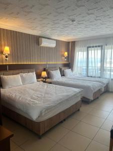 Postel nebo postele na pokoji v ubytování Hotel Stella
