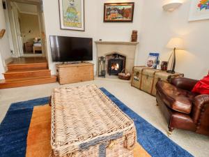 a living room with a couch and a fireplace at Harness Lodge in Seahouses