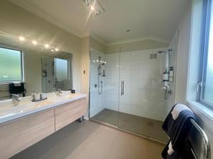 a large bathroom with a shower and a sink at Benrose Park in Palmerston North