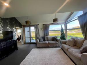 a living room with two couches and a television at Benrose Park in Palmerston North