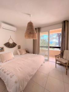 Un dormitorio con una cama grande y una silla. en Casetta Cala Rossa, en Lecci