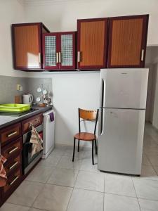 a kitchen with a white refrigerator and a chair at Hurghada Village sea view in Hurghada