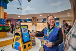 a woman standing next to a video game machine at LEGOLAND(R) Windsor Resort in Windsor