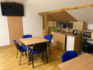 a kitchen and dining room with a table and chairs at Rezydencja pod Gwiazdami in Legarda