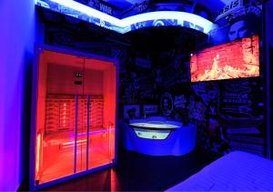 a bathroom with a tub in a room with graffiti at ARTEMIDE "Fiore Club" B&B SUITE SPA in Giffoni Valle Piana