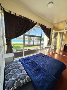 a bedroom with a bed with a view of the ocean at درة العروس - القرية الحالمة - شقة دور أرضي على البحر - Dream Village in Durat Alarous