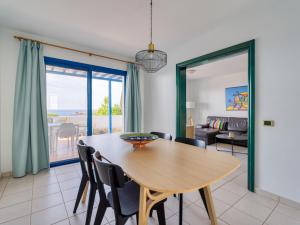a dining room with a table and a view of the ocean at Las Moreras Playa Blanca in Playa Blanca