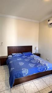 a bedroom with a bed with a blue comforter at درة العروس - القرية الحالمة - شقة دور أرضي على البحر - Dream Village in Durat Alarous