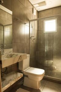 a bathroom with a toilet and a sink and a shower at GoodStay São Paulo Ibirapuera in São Paulo