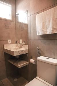 a bathroom with a sink and a toilet at GoodStay São Paulo Ibirapuera in Sao Paulo