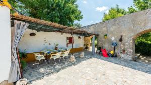 a patio of a house with a table and chairs at Molino Jabonero Villanueva del Trabuco by Ruralidays in Villanueva del Trabuco