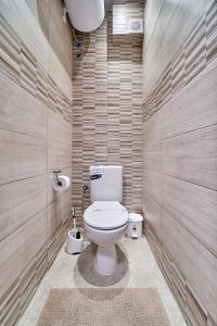 a bathroom with a white toilet in a room at Cozy Apartment with Balcony on the Black Sea- part of the family 'Vicki Apart in Varna City