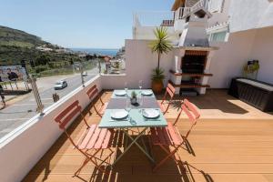 セジンブラにあるCasa das Andorinhas - T2 renovado com terraçoのバルコニーにテーブルと椅子が置かれたパティオ