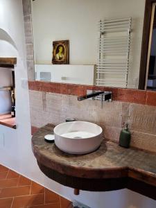 a bathroom with a white sink on a wooden counter at Tuscan dream, lux 2-bed apartment balcony and pool in Anghiari +30 photos