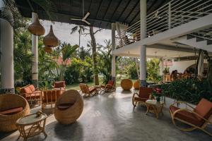 a lobby with chairs and tables and a restaurant at Panta Rei resort in Ahangama