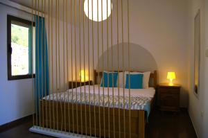 a bedroom with a canopy bed with blue pillows at Yeshill Apart & Studio in Budva