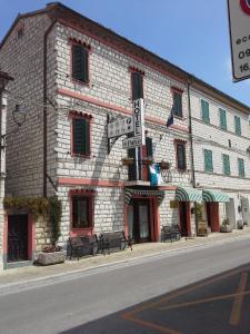 a building on the side of a street with street signs at Hotel Il Parco Sirolo in Sirolo