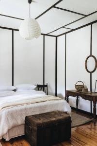 1 dormitorio con 1 cama con dosel blanco y negro en Pickers Hut en Basket Range