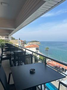 a balcony with a table and chairs and the ocean at Hotel Stella in Kuşadası