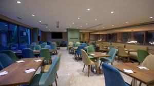 a dining room with wooden tables and chairs at HOTEL BELLE VUE MEKNES in Meknès