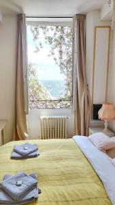 a bedroom with a bed with a large window at Maison Séraphine - Guest house - Bed and Breakfast in Laon