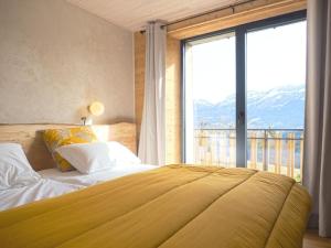 a bedroom with a bed with a large window at Gîte 170m2 6 à 8 personnes 4 chb 4 sdb vue montage au calme in Villard-de-Lans