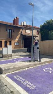 an empty parking lot with a street light next to a building at La Posada del Rancho in Segovia