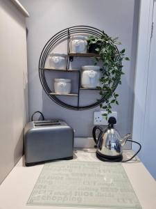 a table with a toaster and a tea kettle at The Boathouse in Lee-on-the-Solent