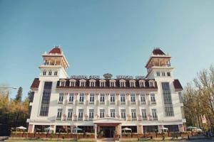 a large building with two towers on top of it at Tskaltubo Plaza Hotel in Tsqaltubo