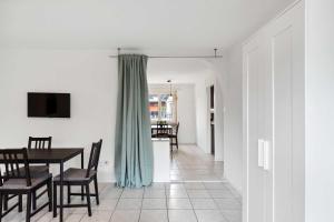 a dining room with a table and chairs and a television at FLEXAPART in Sargans by Fenus in Sargans