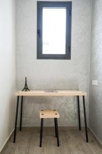 a wooden table with a window on a wall at Charming apartment in Ain Sebaa in Casablanca