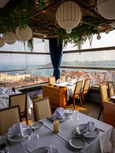 a restaurant with tables and chairs and a view of the city at Cihangir Residences in Istanbul