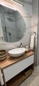 a bathroom with a white sink and a mirror at Centar NS in Novi Sad