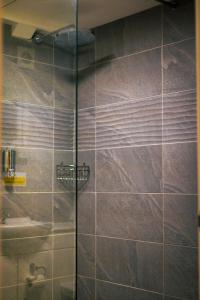 a shower with a glass door in a bathroom at The Old Mill in Coxhoe