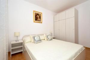 Postel nebo postele na pokoji v ubytování Apartments Sandy