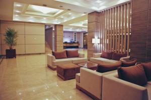 a lobby with couches and a table in a building at Tskaltubo Plaza Hotel in Tskaltubo