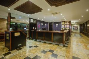 a lobby with a reception desk in a building at Rio Aeroporto Hotel Galeão in Rio de Janeiro