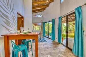 a dining room with a wooden table and blue stools at Hotel Villas Tangerine in Sámara