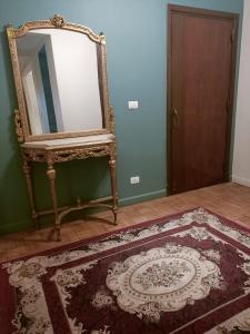 a mirror sitting on a wall next to a rug at Nile view apartment in Cairo