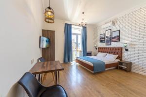 a bedroom with a bed and a table and chairs at Scandinavian Apartments in Kyiv