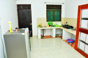 a kitchen with a sink and a refrigerator at Sunil Homestay in Tangalle