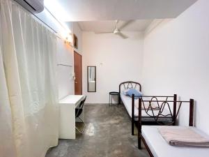 a room with two beds and a sink in it at Tiong Nam 32 Kuala Lumpur, 6 mins to LRT PWTC, 15 mins to KLCC in Kuala Lumpur