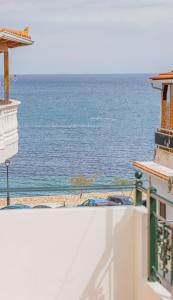 a view of the ocean from the balcony of a building at Scarlett City Apartment in Zakynthos Town