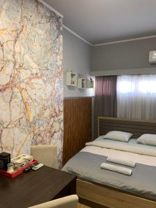 a room with a bed and a map on the wall at Apartman Dacaa in Podgorica