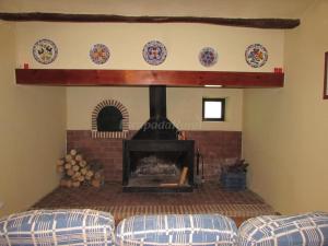 a fireplace in a living room with two couches at CASAS RURALES LA LAGUNA, ALPERA in Alpera +21 photos