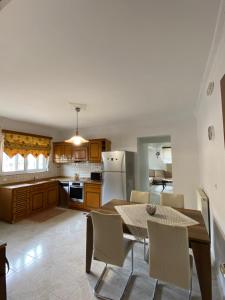 a kitchen with a table and chairs in a kitchen at Kasteli Cozy House in Archangelos